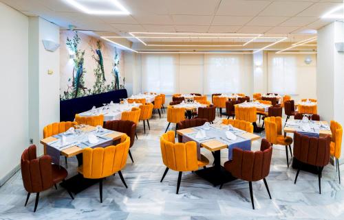 a dining room with tables and chairs in a room at Bellavista Sevilla in Seville