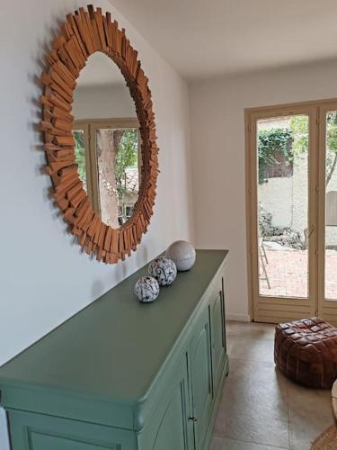 un miroir au-dessus d'une commode dans une pièce dans l'établissement L'Occitane bleu, à Sète