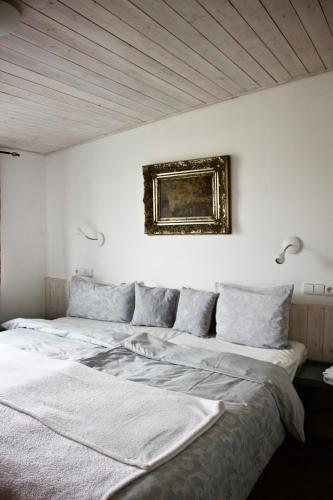 a bedroom with two beds and a painting on the wall at Casas Confort 256 in Boží Dar