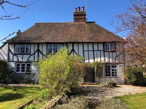 an old black and white house with a roof at Idyllic 15th century farmhouse with hot tub in Petham