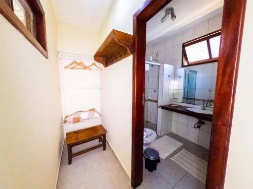 a bathroom with a toilet and a sink at Pousada Maré Alta in Marau