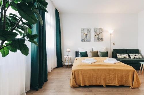 un dormitorio con una cama y un sofá en Homely Apartments Parken Wlan Küche Altstadt-SBahn-DD, Elbufer, en Meißen