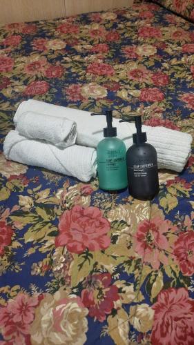 a bed with towels and a bottle of soap on it at Jolie's room in Florence