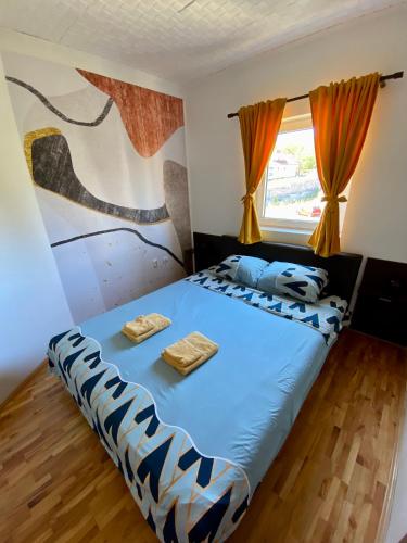 a bedroom with a bed with two towels on it at City view & pool apartment 2 in Niš