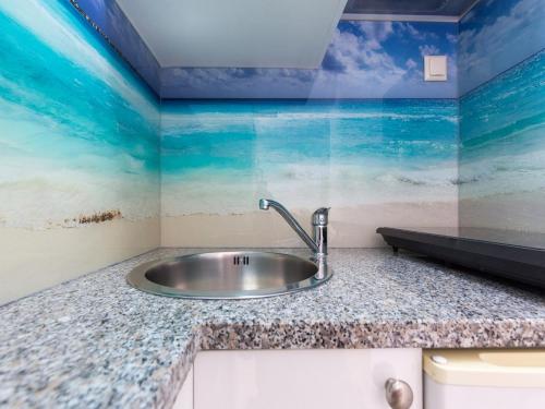 Studio Beach Villa Baška في باشكا: حوض حمام مع جدارية للمحيط