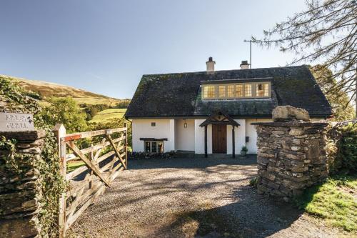 a white house with a gate and a fence at Myley Ghyll, Amazing Views, Troutbeck, Windermere in Windermere