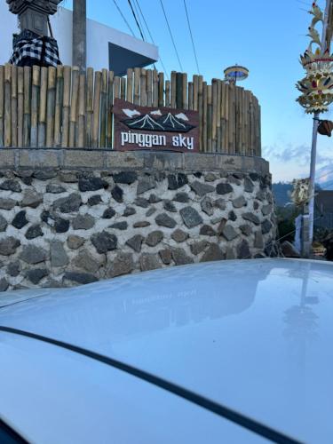 a hood of a car in front of a stone wall at Pinggan sky in Gretek