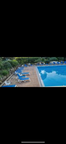une vue sur une piscine avec des chaises longues et une piscine dans l'établissement La corniche d'or - Saint Raphael, à Saint-Raphaël