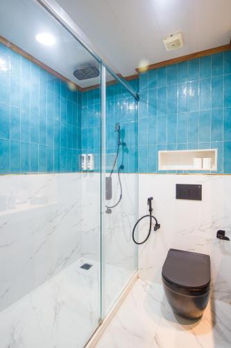 a bathroom with a shower and a toilet at Alaya Stays 3 BHK With Garden - Evaara Woods Breeze in Shimla