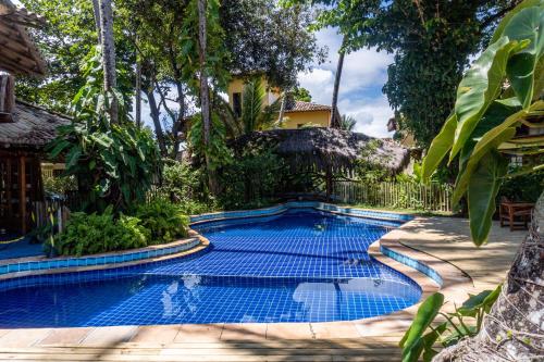a swimming pool in the middle of a yard at Pousada Maré Alta in Marau