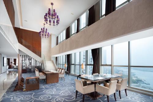a hotel lobby with a table and chairs at Crowne Plaza Zhenjiang by IHG in Zhenjiang