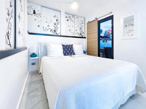a white bedroom with a large white bed in it at Villa Bel Amour, luxury and awesome sea view in Upper Prince's Quarter