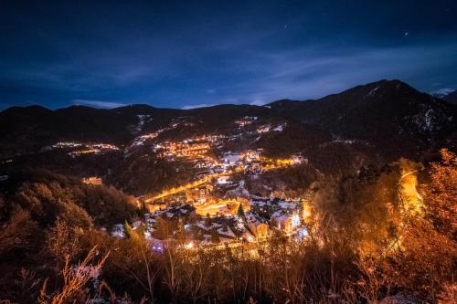 a town in the mountains at night at Hotel AnyosPark Mountain & Wellness Resort in Anyós
