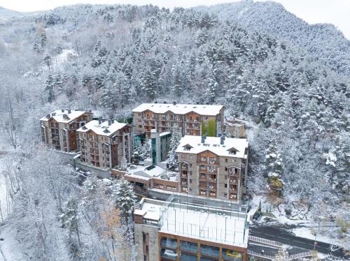 a group of buildings with snow on them at Hotel AnyosPark Mountain & Wellness Resort in Anyós