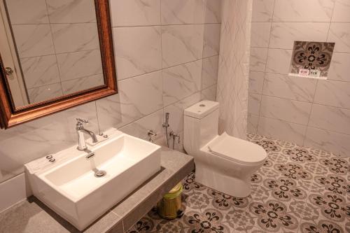 a bathroom with a sink and a toilet at The Farmhouse in Ipoh