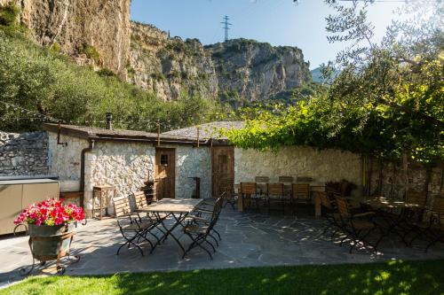 a patio with a table and chairs and a building at Aktivhotel Santalucia in Nago-Torbole