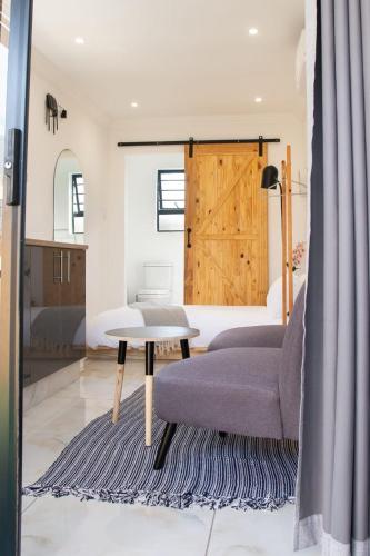 a living room with a couch and a table at Cozy Box Haus in Graskop