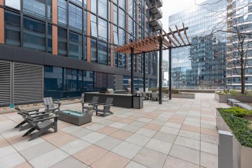 a patio with benches and tables in a building at Bright Apt Downtown with Gym in Boston