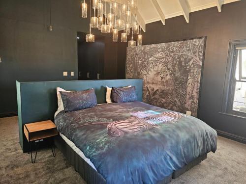 a bedroom with a bed with a zebra blanket at Die Heerenhuys Guest Suites in Stellenbosch
