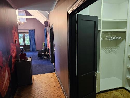 a hallway with a door open to a room at Die Heerenhuys Guest Suites in Stellenbosch