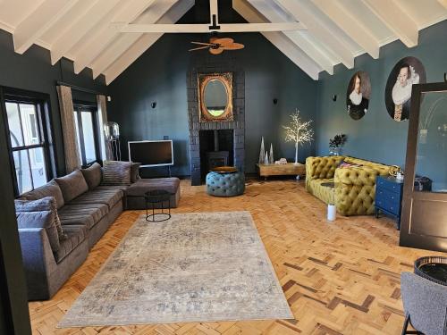 a living room with a couch and a fireplace at Die Heerenhuys Guest Suites in Stellenbosch