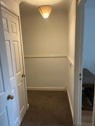 an empty room with a door and a light at Superking bedroom near James cook hospital in Middlesbrough