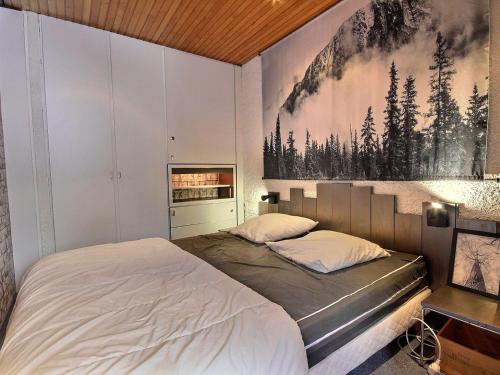 a bedroom with two beds and a painting on the wall at Grand appartement spacieux pour 5 pers., balcon, accès direct aux pistes, Wifi - FR-1-455-167 in La Plagne