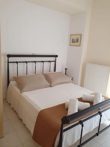 a bedroom with a bed with towels on it at Modern Apartment I & II by Irida Iris Group in Mytilene