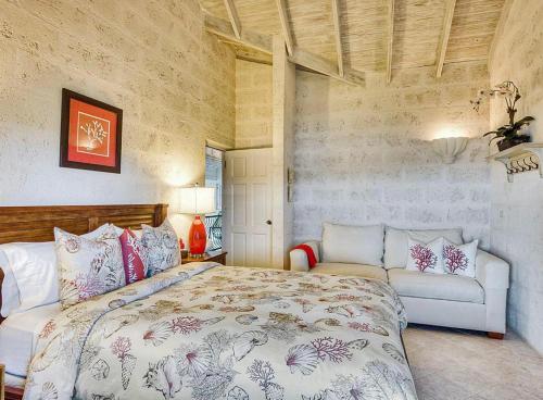 a bedroom with a large bed and a couch at ZenBreak Ocean Mist Villa 3bd in Saint Philip
