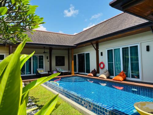 a swimming pool in the backyard of a villa at Tranquil 3 Bedroom Garden Pool Villa in Laguna Phuket