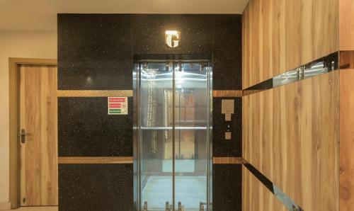 a elevator in a building with a sign on the wall at Hotel Orion Crystal in Kolkata