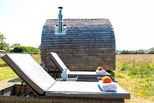 a couple of beds sitting on top of a house at Cabin Westerlands in Selham