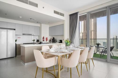a kitchen and dining room with a table and chairs at Casa Nomad - Full Burj Khalifa & Fountain View at Luxury 4 Bed in Dubai