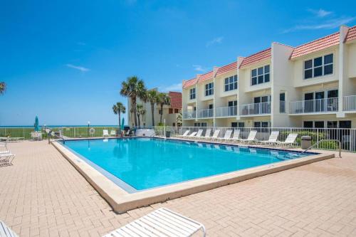 a swimming pool in front of a building at Pier Point 57 in St. Augustine
