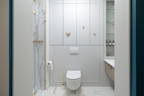 a white bathroom with a toilet and a shower at Sosnowy "3" ,Baseny Tropikalne, Ładowarka do elektryków, Faktura, Parking in Kielce