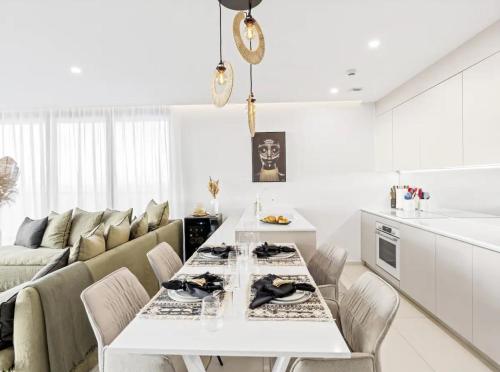 a kitchen and living room with a white table and chairs at B1401 - Fourteen at Mullet Bay, Luxurious and Cosy 2bed apartment with the sea view in Cupecoy