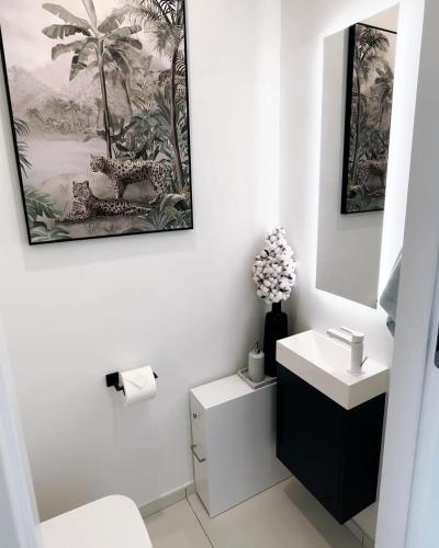 a bathroom with a sink and a toilet and a mirror at B1401 - Fourteen at Mullet Bay, Luxurious and Cosy 2bed apartment with the sea view in Cupecoy