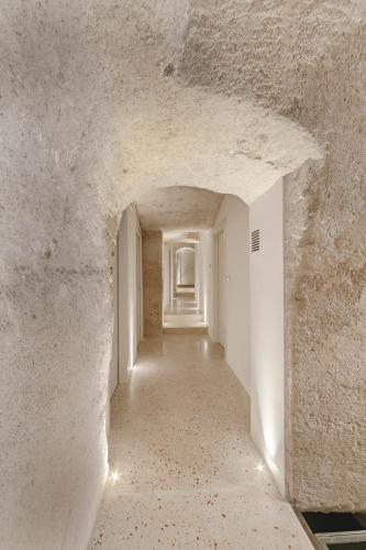 an empty hallway in a building with a white wall at La Dimora Di Metello in Matera