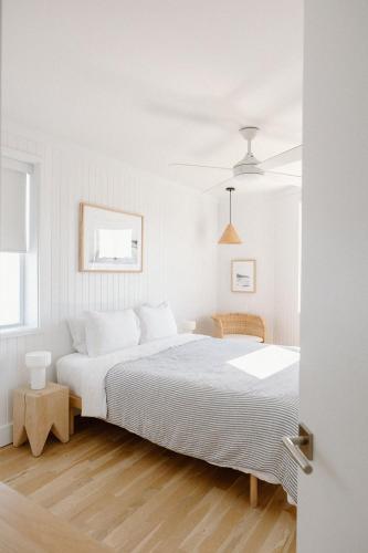 a white bedroom with a large bed in a room at The Sunsetter by WB Abodes in Wrightsville Beach