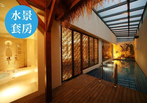 a house with a swimming pool and a sign that at Lanshy Motel in Taichung