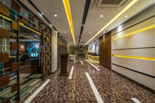 a hallway of a building with a floor of tiles at The Fern Residency Kolkata in Kolkata