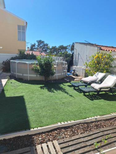 a small yard with chairs and a lawn at sweet susete in Monsoa