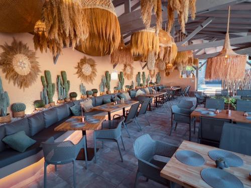 a restaurant with tables and chairs and cacti at Pino - Villa, Casa, Cucina е Terrazza in Albena