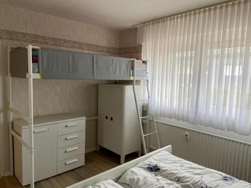 a small bedroom with a bunk bed and a desk at Apartment Tina in Winterberg
