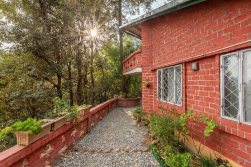 a brick house with plants on the side of it at Unique 2BHK in Bhowali Red Brick Quarter in Bhowāli