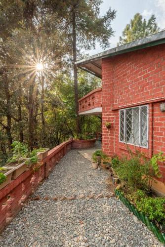 a red brick house with a pathway leading to it at Unique 2BHK in Bhowali Red Brick Quarter in Bhowāli