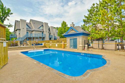 a large blue swimming pool in front of a house at Condo 614 at North Creek Resort in Blue Mountains