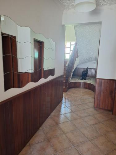 a hallway with a staircase with a dog sitting on the floor at sweet susete in Monsoa