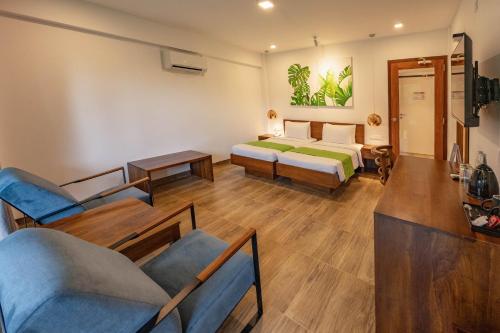 a hotel room with a bed and a couch at Agnus Unawatuna in Unawatuna