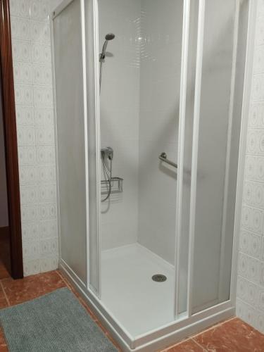 a shower with a glass door in a bathroom at A casiña de Tuli in Vigo